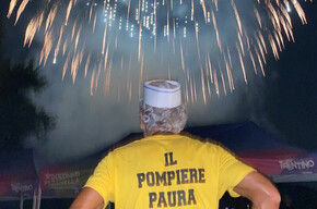 man with his back to the fireworks, on his shirt is the inscription ‘The fireman is not afraid’.