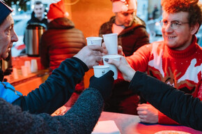 La foto immortala il momento del brindisi tra quattro amici che brindano al natale