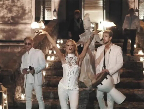  The image shows the group “Miguel Team Group,” consisting of four boys and one girl. They are all dressed in white.