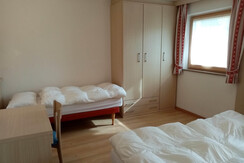room with 3 beds