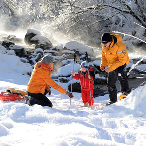 Family in the snow, winter holiday in Trentino